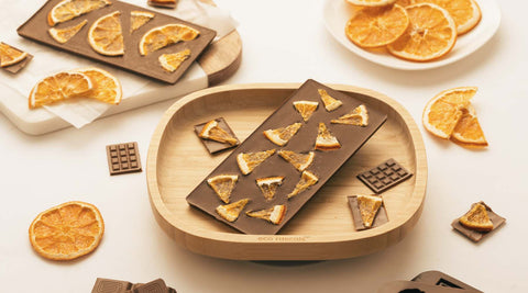 Homemade Chocolate on an eco rascals bamboo open plate with orange segments.