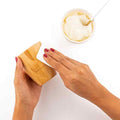 Bamboo cup being coated with coconut oil