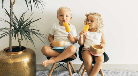 Two children keeping hydrated with lollies