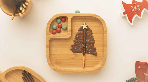 Chocolate Pretzel stick shaped as a chocolate Christmas tree on an eco rascals bamboo plate
