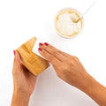 Bamboo cup being coated with coconut oil 