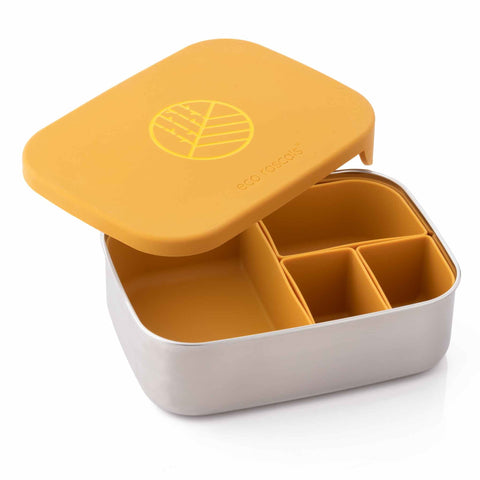 Image shows the classic Mustard eco rascals lunch box bento style with removable dividers with the lid half on and half off to show the inside with matching colour dividers.