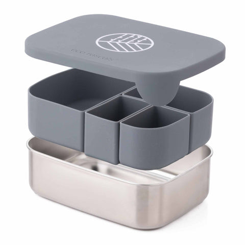 Image shows the classic silver lunchbox by eco rascals with the three sections of the lunchbox floating. The stainless steel open base at the bottom. The removable silicone dividers in the middle and the LFGB silicone lid in silver on top. 