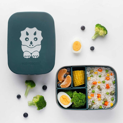 Image shows the dinosaur lunchbox with food inside each of its container. Vegetable rice takes up half of the lunchbox in a s silicone container. Then a boiled egg and broccoli take the quarter container. The two smallest containers are filled with blueberries and orange segments and a corn on the cob. 